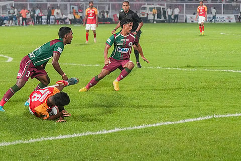 Mohun Bagan vs East Bengal exhibition match: Players of Mohun Bagan and East Bengal (in red) vie for the ball 